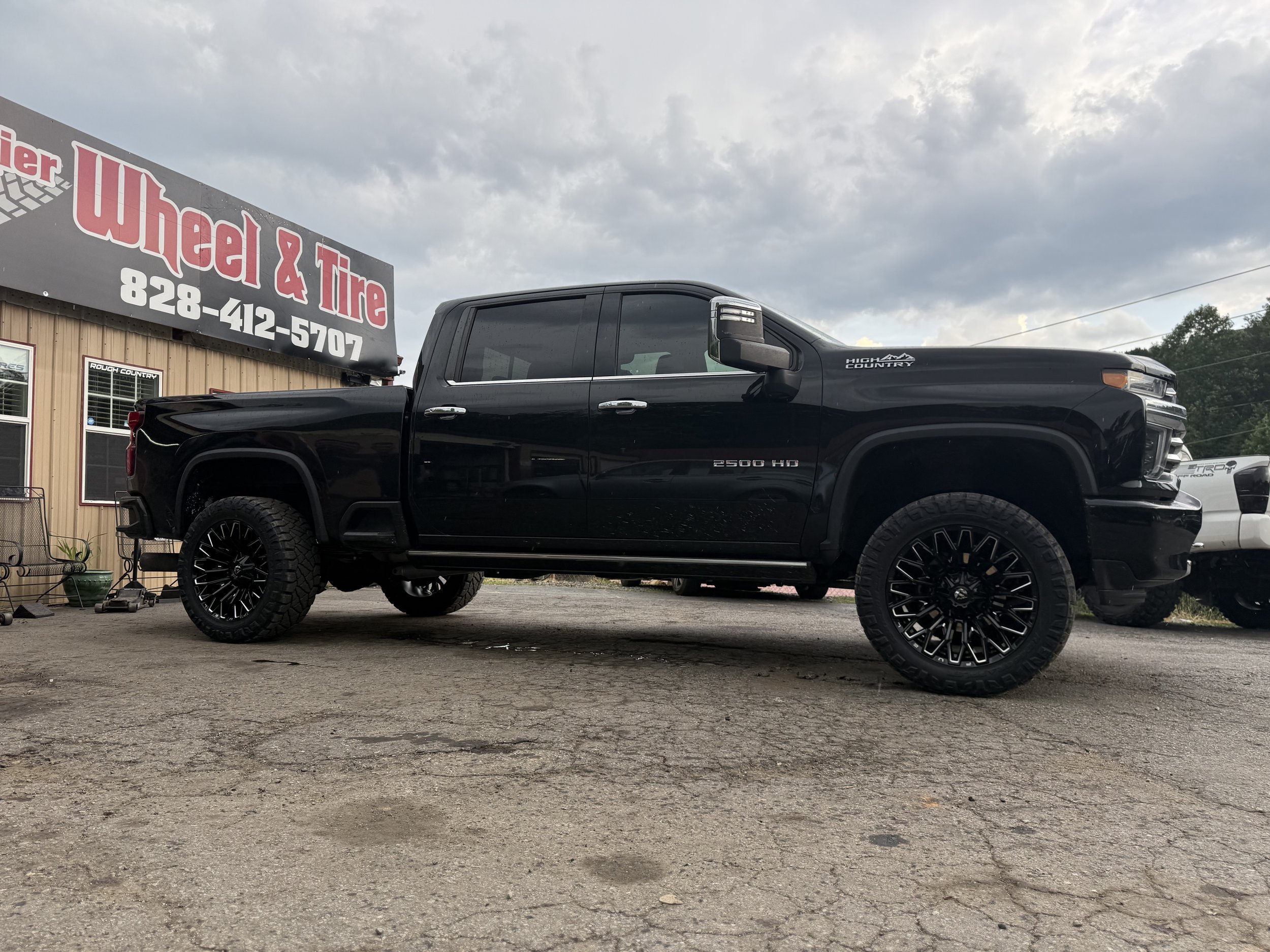Lifted Chevy Silverado HD on gloss black wheels