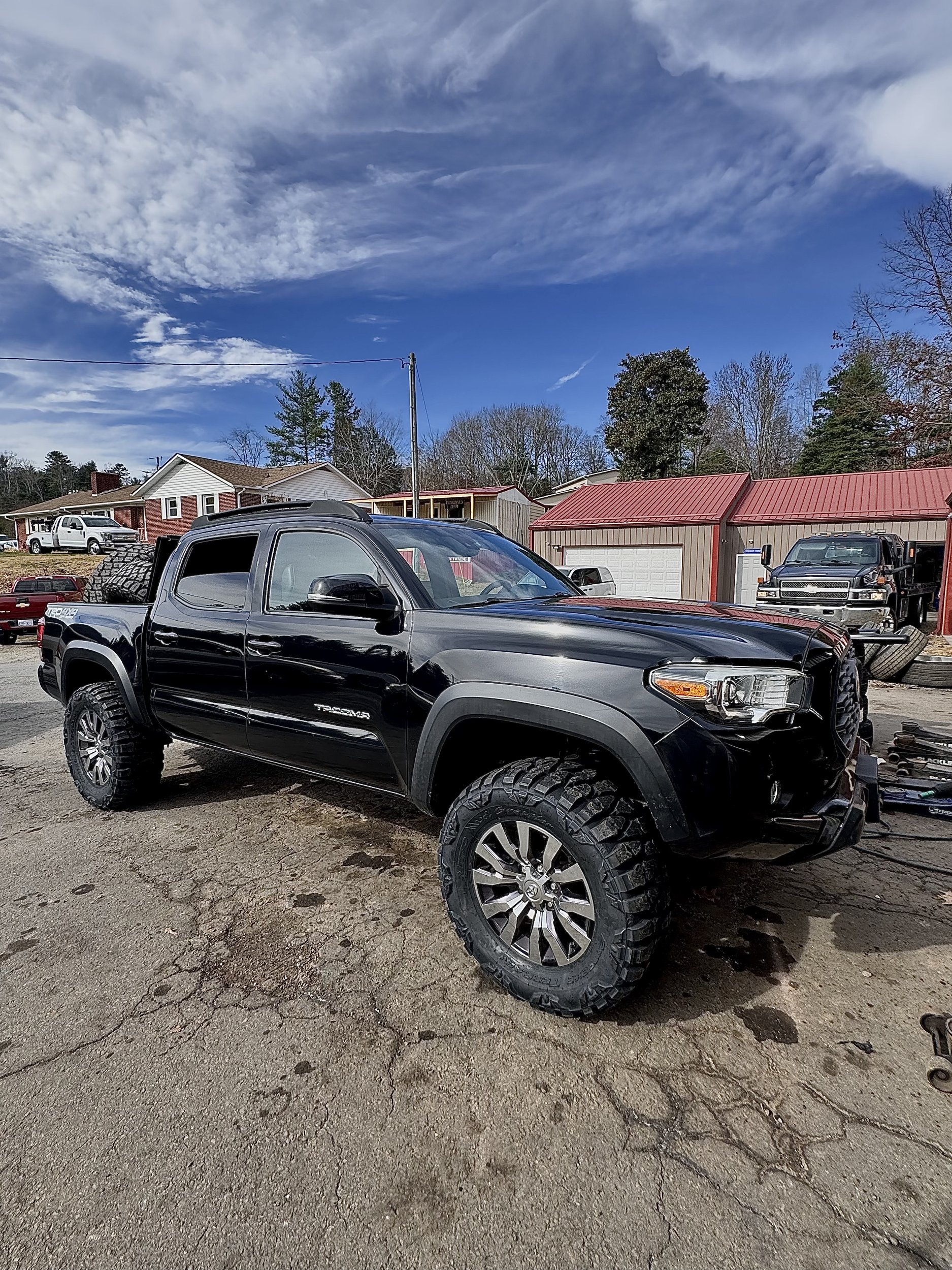 Lifted Toyota Tacoma on custom wheels and mud-terrain tires