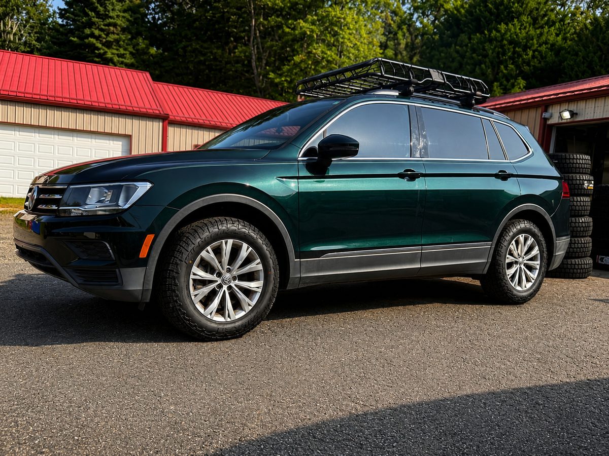 Green Volkswagen Tiguan on new all-terrain tires at our Asheville, NC shop
